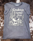 The Cowboys Never Die Distressed Graphic Tee displayed on cowhide.