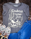 The Cowboys Never Die Distressed Graphic Tee displayed on cowhide along with shoes and jeans,