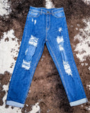 Front view of the Downtown Distressed High-Rise Mom Jeans displayed on cowhide.