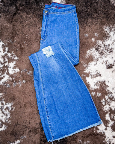 The Shannon Flare Jeans displayed on cowhide.