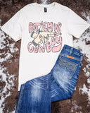 The Put 'Em Up Graphic Tee displayed on cowhide along with jeans and shoes.