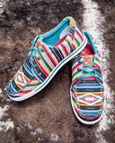 The Paloma Pop Twisted X Hooey Loper displayed on cowhide.