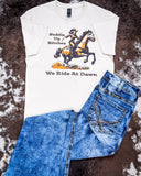The We Ride at Dawn Graphic Tee displayed on cowhide along with jeans,