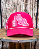 Front view of the Pink Checkered Print Barrel Racer Trucker Cap on a wood table, wood backdrop.