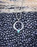 The Moongate Genuine Turquoise Necklace displayed on beans and wheat.