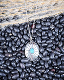 The Abeytu Genuine Turquoise Necklace displayed on beans and wheat.