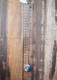 The Abeytu Genuine Turquoise Necklace displayed on a ruler showing size, wood backdrop.