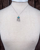 The Abey Genuine Turquoise Necklace shown on a mannequin.