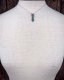 The Arrowhead Genuine Turquoise Necklace shown on a mannequin.