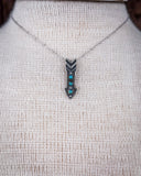 Zoom in of the Arrowhead Genuine Turquoise Necklace displayed on a mannequin.