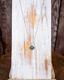 The Catalina Genuine Turquoise Necklace shown on a wood plank.