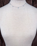 The Alana Turquoise Shaker Necklace shown on a mannequin.