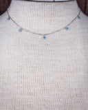 Zoom in of the Alana Turquoise Shaker Necklace shown on a mannequin,