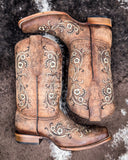 Western Wildflower Circle G Boots laying on cowhide.