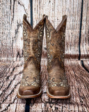 Front view of the Western Wildflower Circle G Boots in front of a wood backdrop.