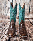 Front view of the Serpent Spur Circle G Boots in front of a wood backdrop.