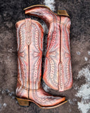 Champagne Rodeo Snip Toe Corral Boots laying on cowhide.