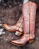 Champagne Rodeo Snip Toe Corral Boots laying on cowhide.
