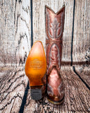 Sole view of the Champagne Rodeo Snip Toe Corral Boots in front of a wood backdrop.