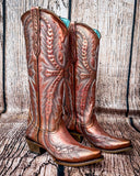 Side view of the Champagne Rodeo Snip Toe Corral Boots in front of a wood backdrop.