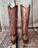 Back view of the Champagne Rodeo Snip Toe Corral Boots in front of a wood backdrop.