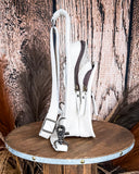 Right side view of the Ridge Bloom Tooled Sling Bag - Ivory on a wood backdrop.