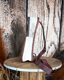 Left side view of the Cimarron Tooled Sling Bag on a wood backdrop.