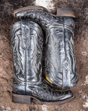 The Midnight Slither Corral Boots displayed on cowhide.