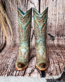 Front view of the High Noon Belle Corral Boots in a wood backdrop.