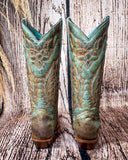 Back view of the High Noon Belle Corral Boots in a wood backdrop.