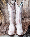Front view of the Dust Rose Canyon Corral Boots with a wood backdrop.