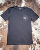 Front view of the Coyote Hooey T-Shirt displayed on cowhide.