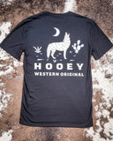 Back view of the Coyote Hooey T-Shirt showing graphics, displayed on cowhide.