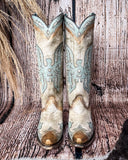 Front view of the Skyward Spirit Corral Boots with a wood backdrop.