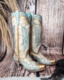 Side view of the Skyward Spirit Corral Boots with a wood backdrop.