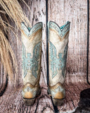 Back view of the Skyward Spirit Corral Boots with a wood backdrop.
