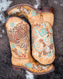 The Sandstone Stallion Corral Boots displayed on cowhide.