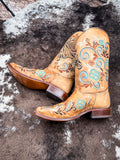 The Sandstone Stallion Corral Boots displayed on cowhide.