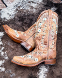 The Luminous Petal Corral Boots displayed on cowhide.