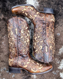 The Desert Blossom Corral Boots displayed on cowhide.