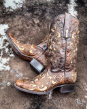 The Desert Blossom Corral Boots displayed on cowhide.