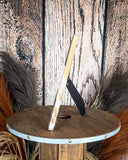 Side view of the Myra Bag - Tumbleweed Trail Photo Frame in Brown and White on a wood background.