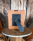Back view of the Myra Bag - Mesa Plateau Photo FramePhoto Frame on a wood background.