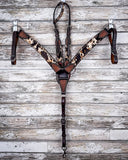 The Breast Collar and Single Ear Headstall displayed on a wood back drop.