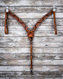 The Turquoise Sunflower Tooled Breast Collar displayed on a wood backdrop.