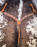 The Turquoise Sunflower Tooled Breast Collar displayed on cowhide. 