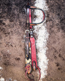 The Peppered Hair On Hide Headstall folded while being displayed on cowhide.