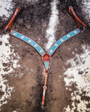 The Turquoise Wash Bull Coin Breast Collar displayed on cowhide.