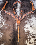 The Turquoise Sunflower Tooled Breast Collar and Browband Headstall displayed on cowhide.  