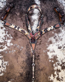 The Peppered Hair On Hide Breast Collar and Browband Headstall displayed on cowhide.